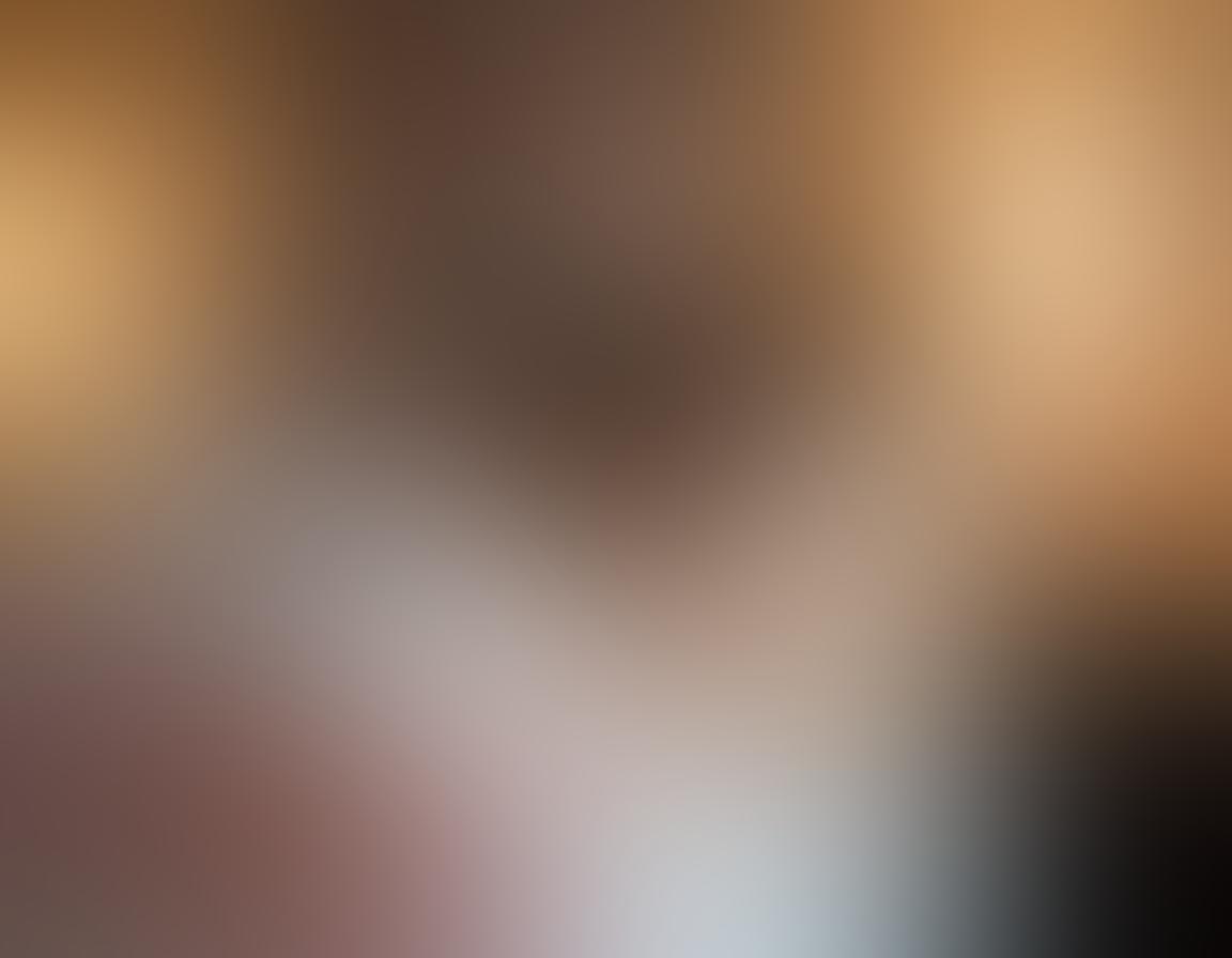 An intimate and inviting bedroom scene featuring a couple exploring pleasure products together. Soft, ambient lighting enhances a romantic atmosphere, while luxurious textures and colors create a sense of warmth. Include an assortment of elegant pleasure products tastefully displayed on a plush bed, with hints of playful accessories like feather ticklers and silk ties. Emphasize connection and intimacy, capturing a joyful and adventurous spirit. super-realistic. soft lighting. warm colors.